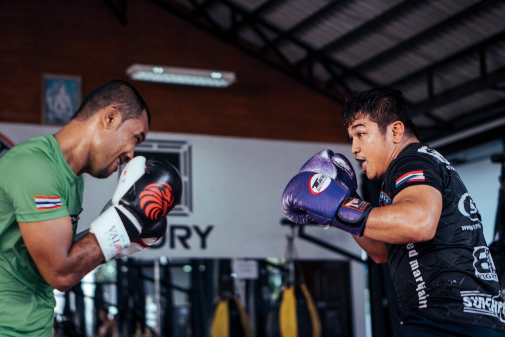 two men fighting in boxing ring